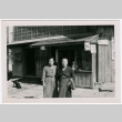 Two Japanese women stand before the front of a building (ddr-densho-348-13)