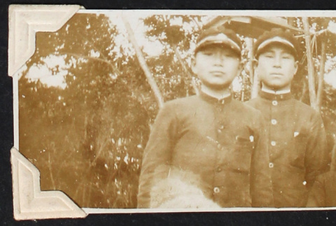 Man stands with three boys in school uniforms (ddr-densho-404-37)