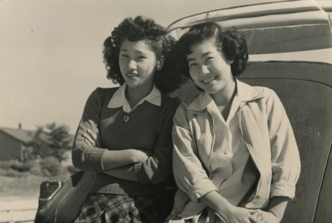 Two Japanese Americans in front of a car (ddr-densho-159-83)