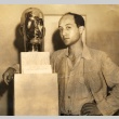 Isamu Noguchi posing with a sculpture (ddr-njpa-4-1489)