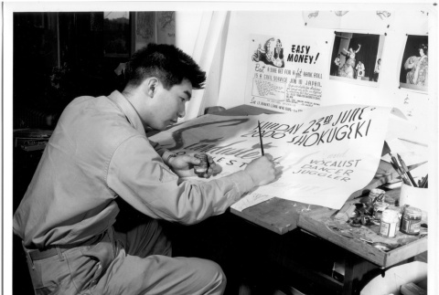 Nisei soldier painting a sign (ddr-densho-114-154)