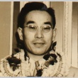 Morinosuke Kawasaki wearing leis after arriving on the Tatsuta Maru (ddr-njpa-4-573)