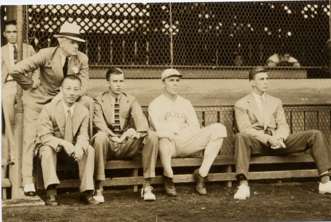 Men sitting on a bench and a Harvard baseball player (ddr-njpa-1-1632)
