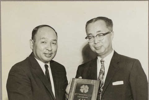 Yasuo Goto holding a 4-H club member plaque (ddr-njpa-5-1128)