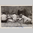 Six people sitting on ground at picnic (ddr-densho-464-53)