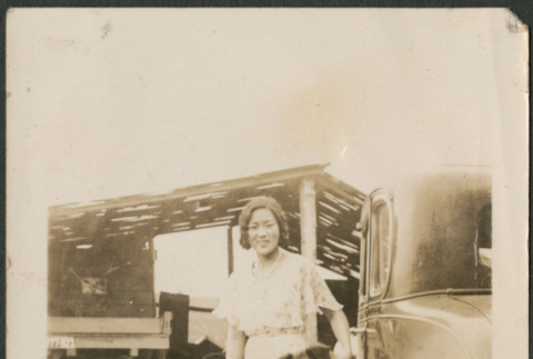 Woman and dog by car (ddr-densho-316-204)