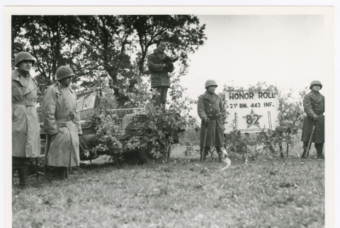 Captain Hiro Higuchi, chaplain, reading scripture at 442nd Infantry Regiment Honor Roll on Armistice Day (ddr-densho-1007-142)