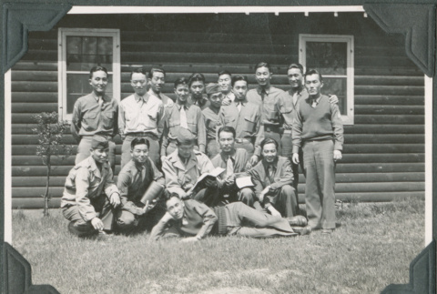 Men posing for group photo outside camp building (ddr-ajah-2-510)