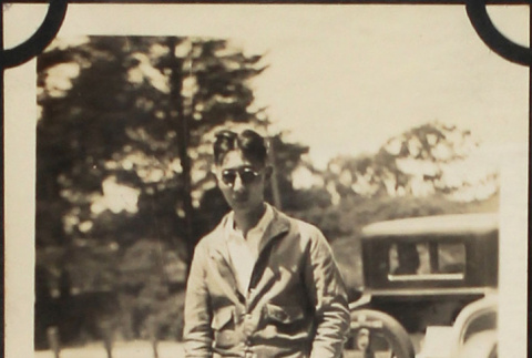 Man in sunglasses standing near car (ddr-densho-423-512)