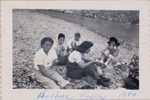 Group picnicking by river (ddr-densho-464-31)
