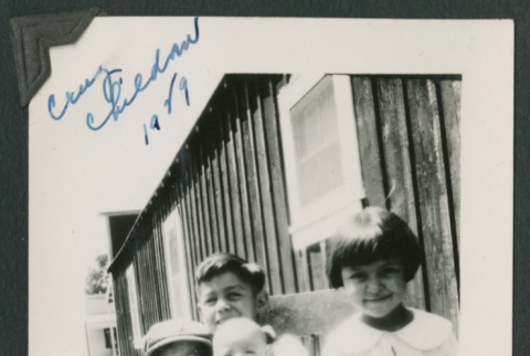 4 kids around a chair outside (ddr-densho-378-727)