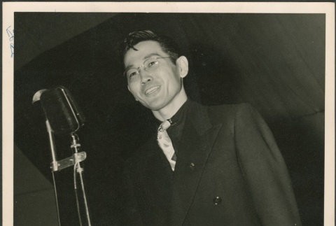 A man in front of a microphone (ddr-densho-298-300)