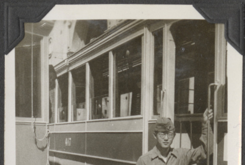 Man standing next to train car (ddr-densho-466-671)