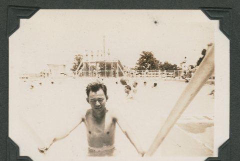 Man exiting swimming pool (ddr-densho-545-41)