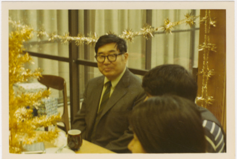 Henri Takahashi seated at a table (ddr-densho-426-158)