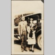 Issei man and woman in front of a black car (ddr-densho-259-218)