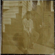 A young man sitting on front steps (ddr-densho-321-1191)