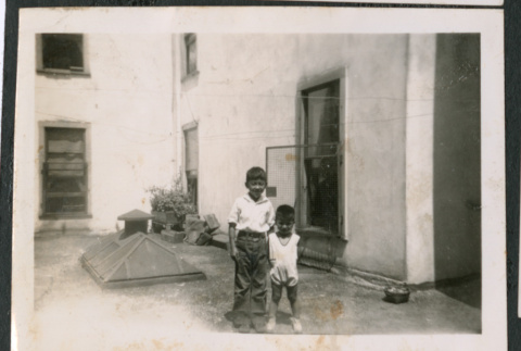 Photo of two children on a roof (ddr-densho-483-807)