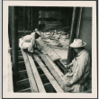 Two men laying flooring (ddr-densho-426-2275)