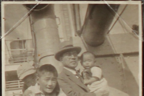 Father and three sons aboard a ship en route to Japan (ddr-densho-259-15)