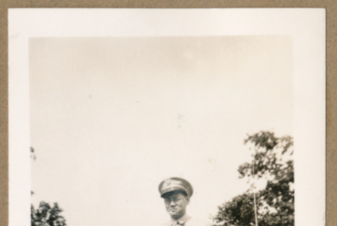 Soldier poses in front of car (ddr-densho-368-502)