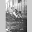 Eiko Hibiya poses with a seated man and two children (ddr-densho-381-184)