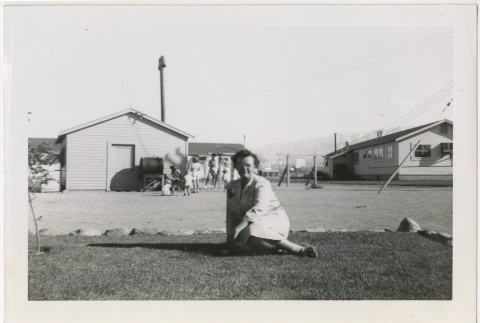 Woman sitting in front of school playground (ddr-manz-7-41)
