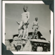 Soldier standing next to a statue (ddr-densho-201-607)