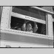 Child looking out of bus window (ddr-densho-151-174)