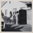 women walking through gate in driveway (ddr-densho-522-96)