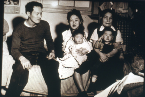 Three adults on couch with children (ddr-densho-1007-624)