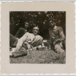 Three people laying on grass (ddr-densho-458-16)