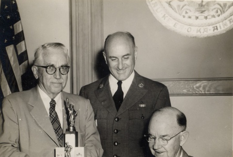 Wade Warren Thayer and Boy Scouts leader receiving a trophy from Oren E. Long (ddr-njpa-2-1144)