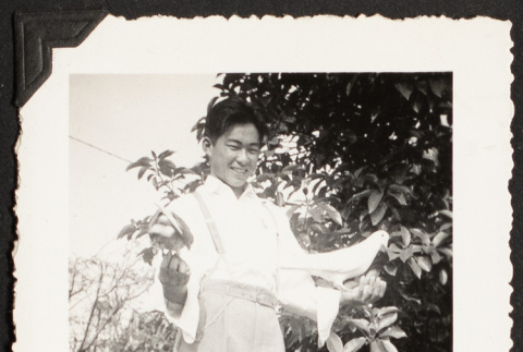 Yosh Kikawa holding two pigeons (ddr-densho-542-367)