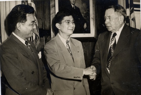 Mike Masaoka shaking hands with a man (ddr-njpa-1-969)