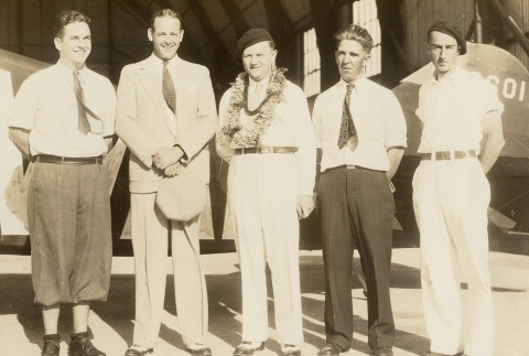 A group of men in front of an airplane hangar (ddr-njpa-1-2336)