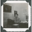 A woman typing in an office (ddr-densho-300-208)