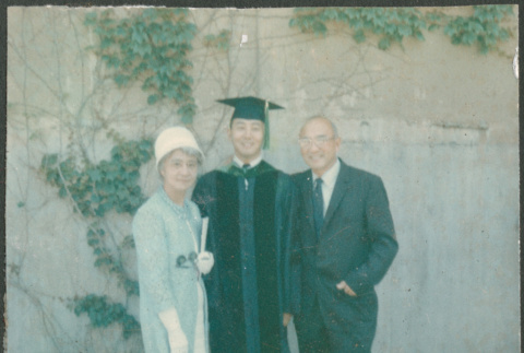 Man in graduation robe with Agnes and Chester Sakura (ddr-densho-523-429)