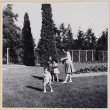 Woman with three children playing on lawn (ddr-densho-522-13)