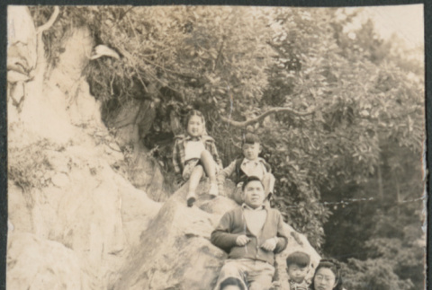 Family seated on rocks (ddr-densho-523-66)