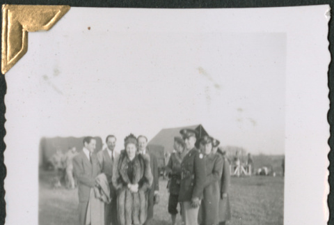 Woman in fur coast with group of men (ddr-densho-434-83)