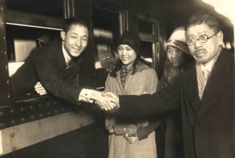 Tennis player, Minoru Kawachi, and others posing by a train (ddr-njpa-4-555)