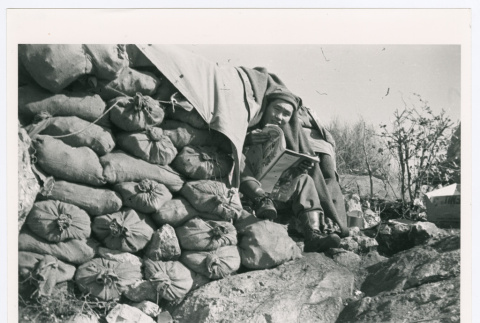 Man reading in sandbags (ddr-densho-1007-352)