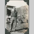 Man standing in yard in front of house (ddr-ajah-2-346)