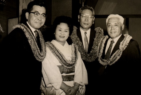A woman and three men wearing leis (ddr-njpa-4-1684)
