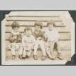 Four children sitting on steps (ddr-densho-355-446)