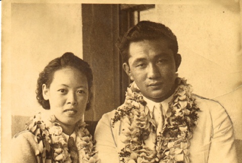 A wrestler and a woman wearing leis (ddr-njpa-4-2675)