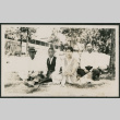 3 men and 1 woman sitting in a yard (ddr-densho-378-830)