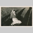 A woman sitting in a field (ddr-densho-338-102)