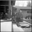 Boulder with carved face on house patio (ddr-densho-377-1575)